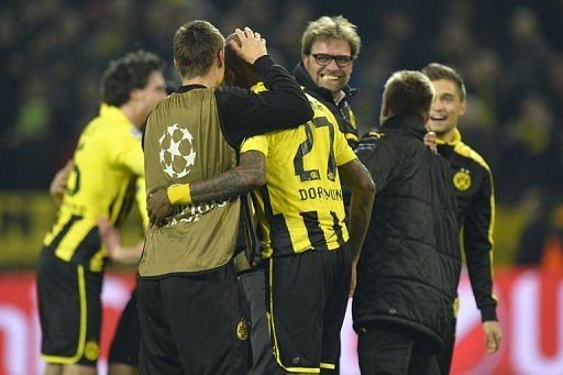 Dortmund's head coach Juergen Klopp celebrates with Felipe Santana (C) who scored the winning goal on April 9, 2013